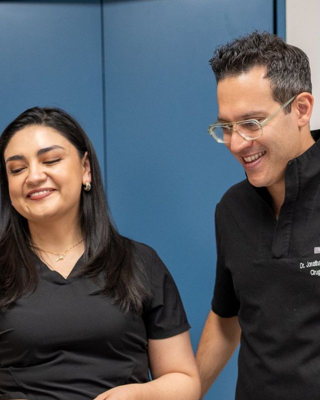 Dr. Zaga in scrubs with a member of his care team at the hospital