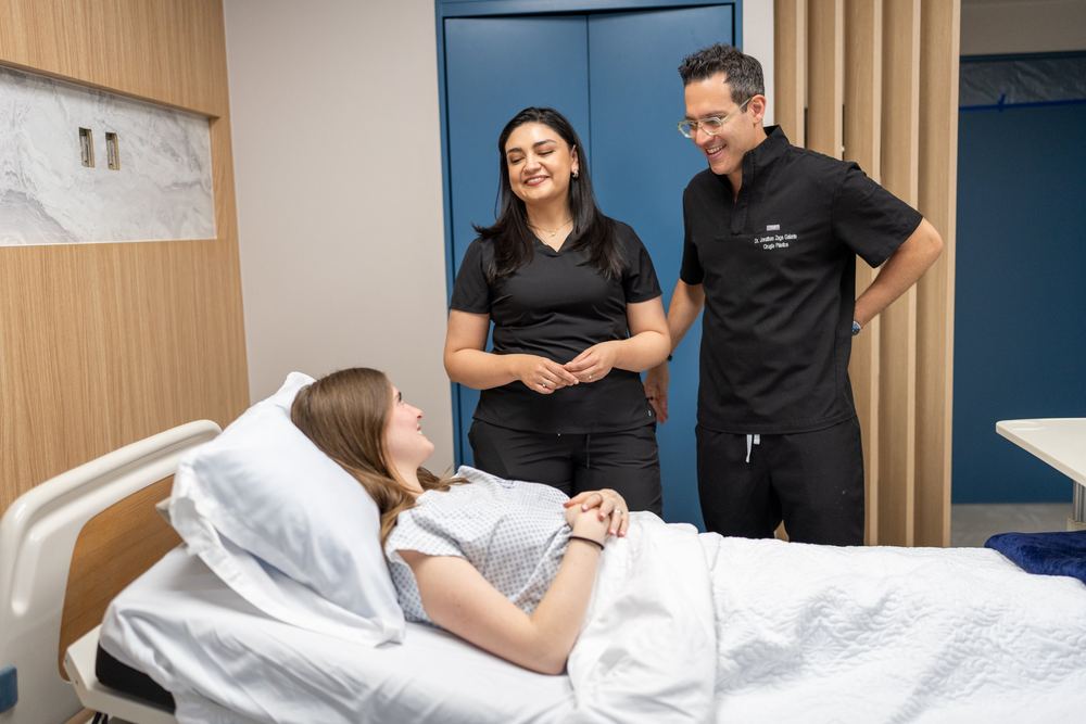 Dr. Zaga and a member of his team visiting a patient during recovery